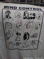 Close-up of white 'Mind Control' graphic print t-shirt