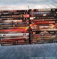 Two stacks of DVD cases showing a total of 30 movies, mix of popular titles including The Chronicles of Riddick, Lord of the Rings, Harry Potter and others mainly in good condition.
