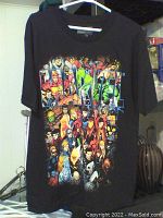Full view of black Marvel t-shirt hung on white hanger showing front Marvel superhero character graphic.