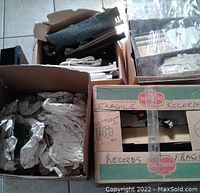Boxes containing various vending machine spare parts wrapped in paper cushioning, fragile markings visible.
