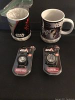 Photo showing two Star Wars ceramic mugs; Darth Maul mug has a broken handle but handle included. Also shows two new Star Wars watches in original packaging with 3D character faces.