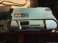 Top photo of Bosch PBS 75 belt sander showing model label and general wear.