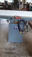 Front view of jointer on stand with cutter head and laminated fence