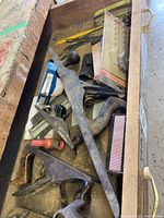 Wide shot of assorted metal hand planes and accessories in wooden case
