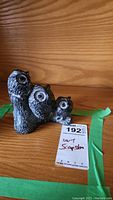 Front and side views of the soapstone carving showing detailed owl designs and textured feathering.