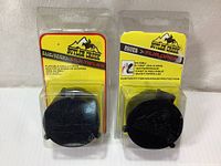 Two packaged Butler Creek flip-open scope covers, one Multi-Flex for 33-34 OBJ and one Waterproof for 34 OBJ, displayed side by side front view showing product and brand packaging.