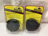 Front view of two Butler Creek Flip-Open Scope Covers Multi Flex in original packaging with yellow backing showing size and model information.