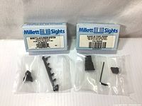 Two sealed Millett Sights boxes with contents displayed: Beretta Accurizer System and Ruger 22 Fixed Combo sight sets.