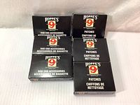 Six new packs of Hoppe's 9 products including rod end accessories and cleaning patches in black boxes.