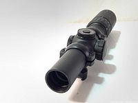 Side view of black cylindrical crossbow scope with adjustment turrets and 24mm lens.