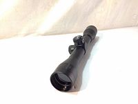 Angle view of the Excalibur crossbow scope showing the front 32mm lens and black matte finish.