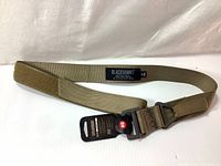 Full view of Blackhawk 1.75 inch CQB Rigger's Belt laid flat showing buckle and size tag, tan color, new with tags.