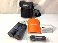 Full view of binocular set showing binoculars, carrying case, quick start guide, small parts kit, strap and instruction manual.