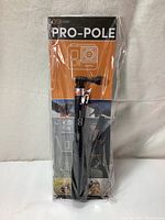 Front view of the Pro-Pole selfie stick in packaging, showing branding and product mount.