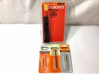 Photo displaying full lot of items including Millett scope mounts and Hoppe's Elite cleaning rod accessories in original packaging.