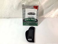 Full packaging alongside the black holster with clear visibility of branding and size label.