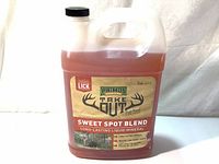 Front view of 1-gallon jug with label showing product name Primos Hunting Take Out Sweet Spot Blend Long-Lasting Liquid Mineral and branding details.