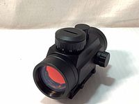 Front angled view showing red-tinted lens and adjustment dials