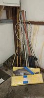 Photo of fishing rods, metal handle net, and yellow tackle boxes placed together, showing overall set contents.