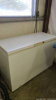 Full side view of the Kenmore white chest freezer near window with visible size and shape.