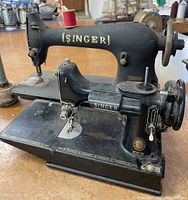 Overview of two Singer sewing machines side by side on a tabletop