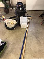 Photo showing the full lot on a concrete floor including the Shop Vac, buckets, broom, and other attachments.