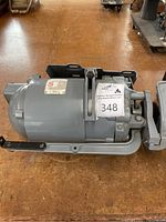 Side view of Singer motor showing metal housing and mounting base.