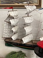 Close-up photo of the wooden model ship's sails and rigging