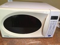 Front view of Danby microwave oven showing windowed door and keypad control panel