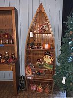 Full front view of the boat-shaped bookcase with décor removed.