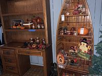 Fall decorations arranged on and around wooden desks and shelves including turkey figurines, faux pumpkins, candles, baskets, and a 'Give Thanks' sign.