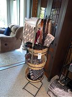 Overview of basket rack with several bags and belts displayed, including patterned and quilted bags and several belts hanging
