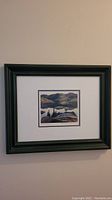Framed print hung on wall showing the full artwork and frame.