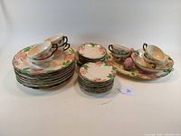 Full set of 36 piece Franciscan Pottery dinnerware displayed including plates, teacups with saucers, and additional items.
