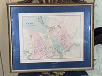 Framed antique-style map print showing the City of Lynn with different colored districts and geographic details.