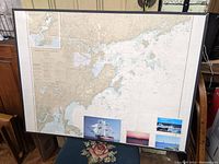Full frontal view of framed nautical chart showing Salem and Lynn Harbors with seller's notes and pictures attached to inside bottom of frame.