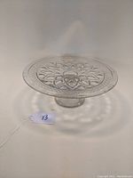 Top view showing detailed floral and geometric Cape Cod pattern etched onto the clear glass surface of the cake plate.