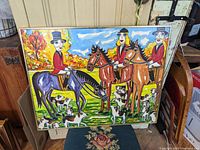 Full frontal view of the colorful oil painting on board depicting three jockeys on horses with dogs in a landscape setting.