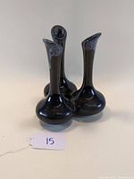 Front and side views of dark blue Van Briggle triple bud vase, showing shape and glaze