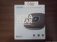 Retail box of Anker Ultra Clear portable conference speaker showing front branding and features.