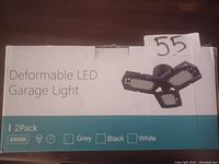Box displaying two deformable LED garage lights, white color, 6500K color temperature, indicating a 2-pack.