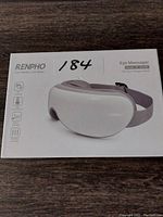 Photo of the RENPHO Eye Massager box showing the product image and key features such as heat, vibration, and music for eye fatigue relief.