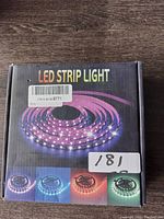 Box front showing LED strip light image and multi-color lighting.