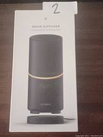 Boxed Vitruvi Move essential oil diffuser black model with product image and labeling on front.