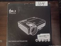 View of the sealed box featuring the BR.J Professional Multimedia LED Projector illustration and branding