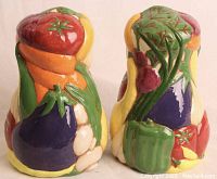 Front and back sides of hand-painted ceramic salt and pepper shakers showing vibrant vegetable designs