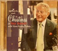 Photo of the Christmas with Tony Bennett and the London Symphony Orchestra CD cover, showing Tony Bennett in a dark suit with a light tie, with gold starburst Christmas decoration graphics on cover.