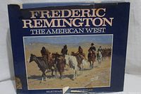 Front cover of the hardcover book showing the title, artist's name, and artwork of riders on horseback in the American West.