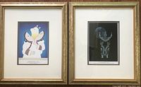 Photo of both framed Inuit artist prints side by side in gold-tone frames with double off-white and blue matting.