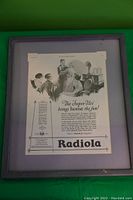 Framed 1925 Radiola advertisement showing family using radio with wooden rustic frame.
